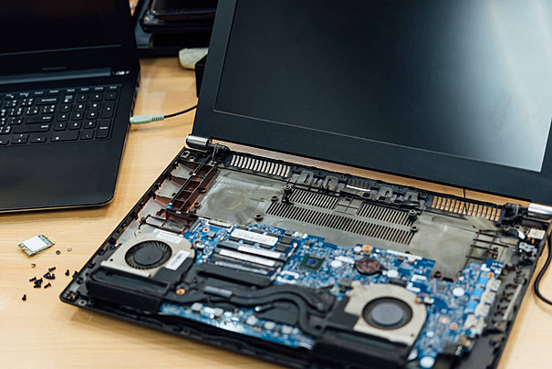 Home pngtree inspecting a laptop for repairs at the repair shop photo image 31652466