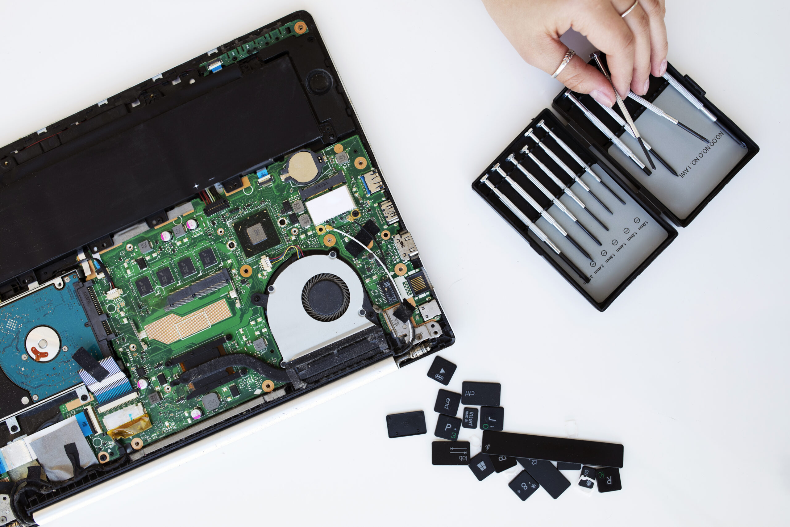 Home young woman cleaning her laptop key board